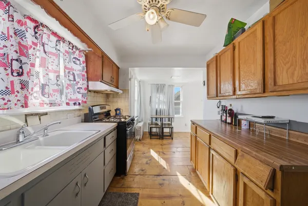 a kitchen with a sink and a stove top oven