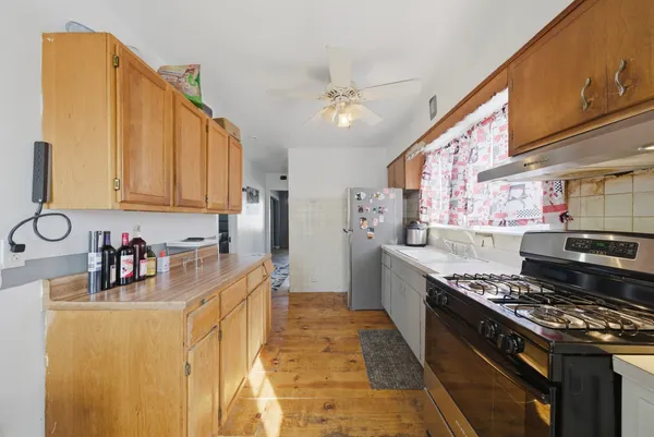 a kitchen with stainless steel appliances granite countertop a stove and a sink