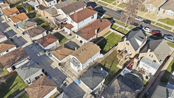 an aerial view of houses with outdoor space