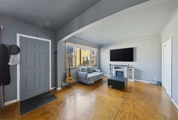 a living room with furniture and a flat screen tv