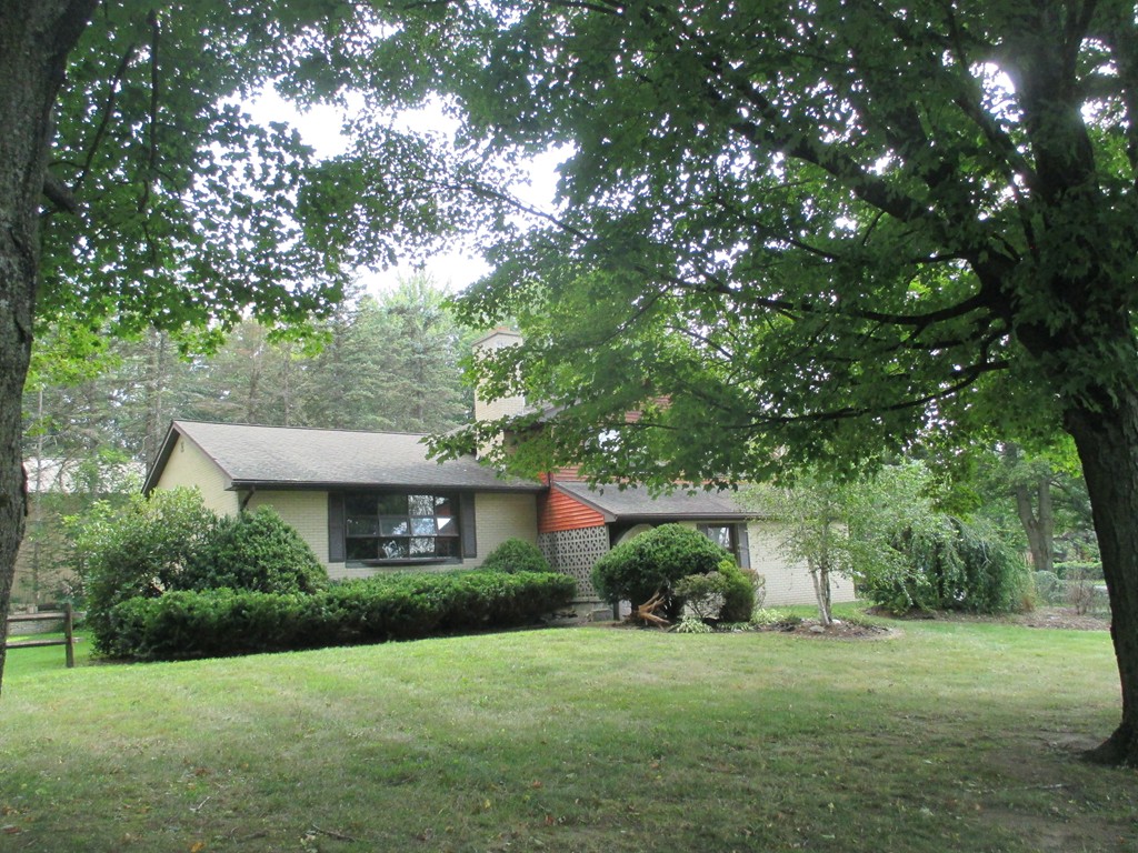 2 Barton Street Granby, MA 01033 - Photo 1 of 24 a front view of a house with a yard and trees
