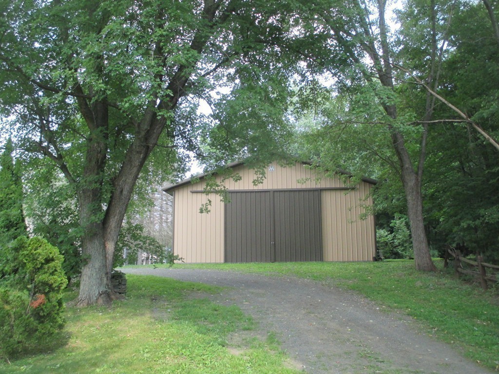 2 Barton Street Granby, MA 01033 - Photo 20 of 24 a view of a house with a tree and a yard