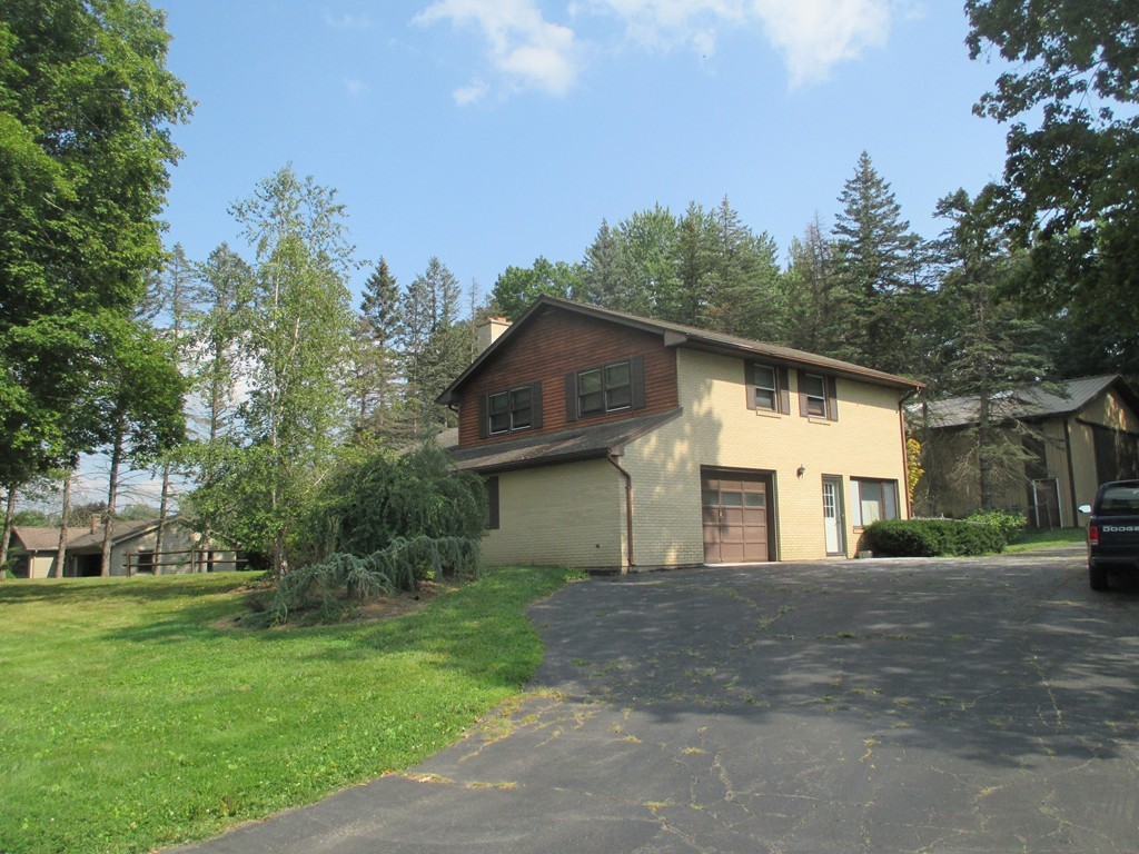 2 Barton Street Granby, MA 01033 - Photo 2 of 24 a front view of a house with a garden