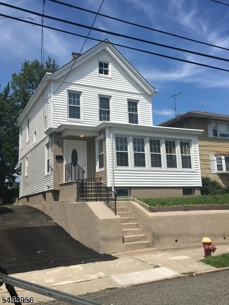 16 Mineral Spring Avenue Passaic, NJ 07055 - Photo 1 of 1 a front view of a house with a yard