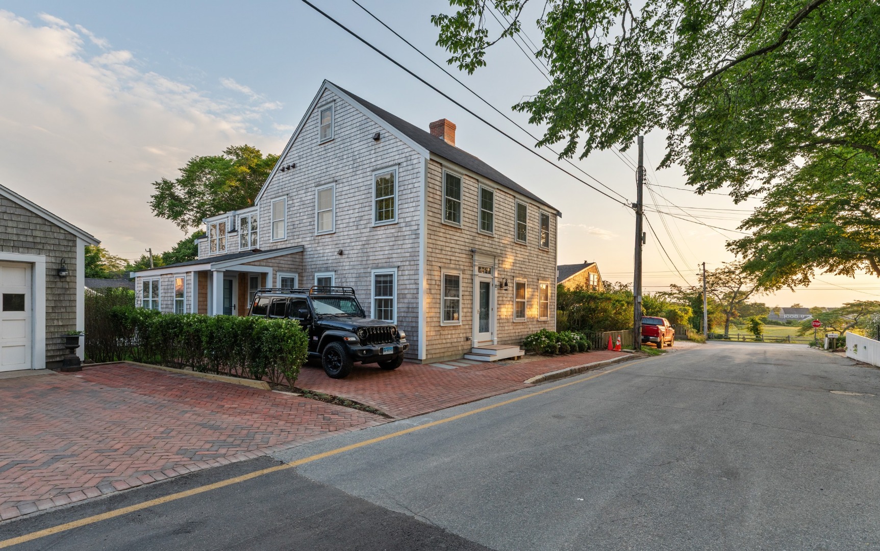 22 Vestal Street Nantucket, MA 02554 - Photo 6 of 43 a front view of a house with a yard and garage
