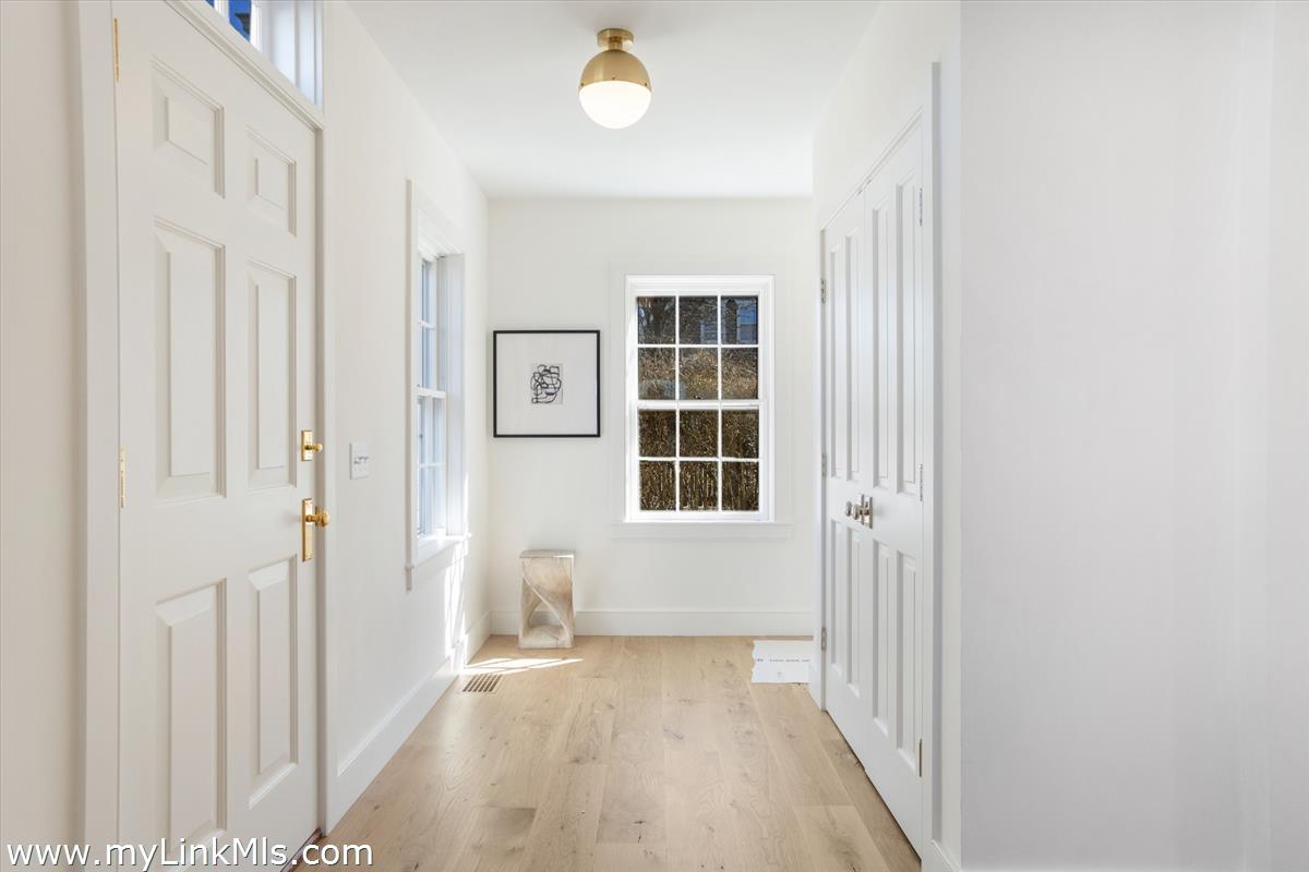 22 Vestal Street Nantucket, MA 02554 - Photo 10 of 43 an entryway of a house with wooden floor and windows