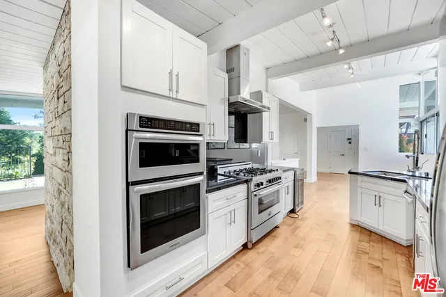 a kitchen with stainless steel appliances granite countertop a stove and a refrigerator