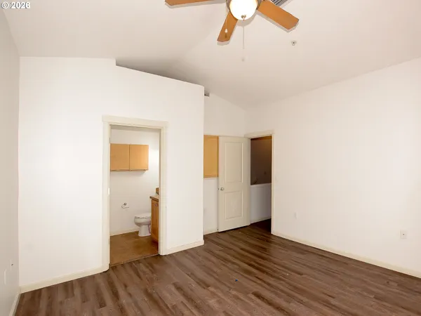 a view of a room with wooden floor and white walls