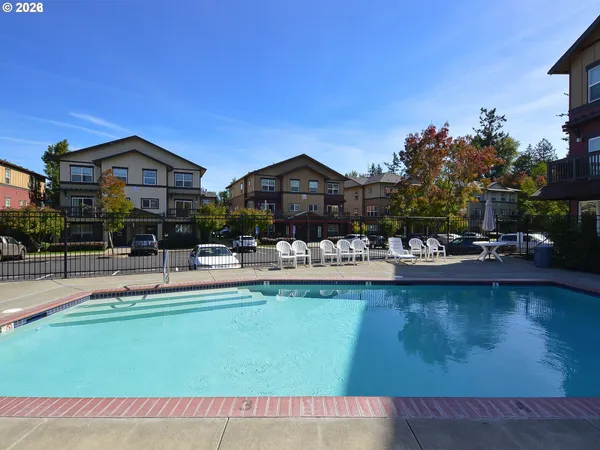 a front view of a house with swimming pool having outdoor seating