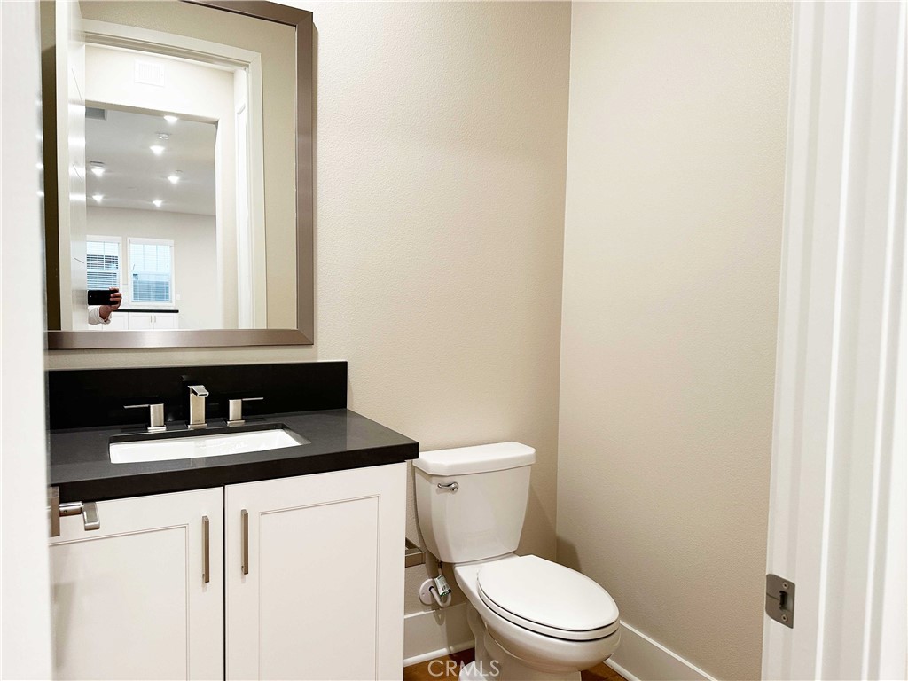 58 Ray Irvine, CA 92618 - Photo 12 of 35 a bathroom with a granite countertop toilet sink and mirror
