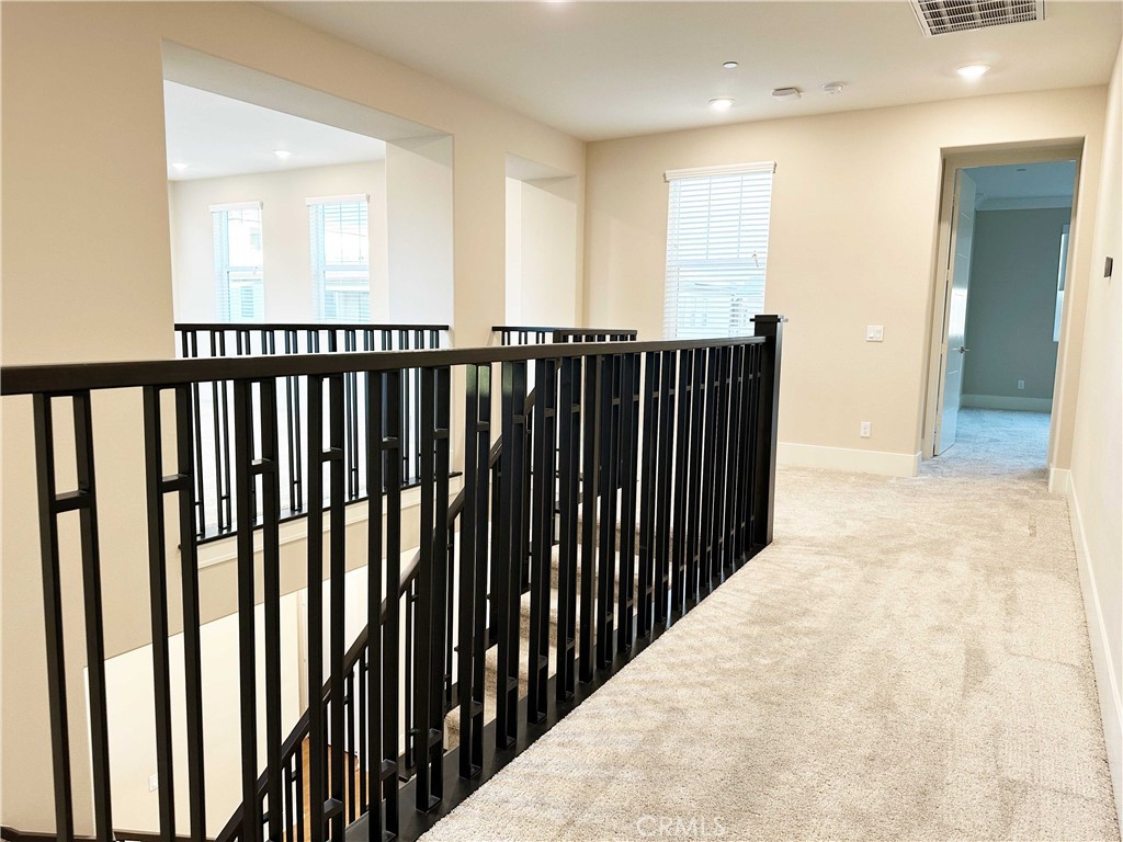 58 Ray Irvine, CA 92618 - Photo 18 of 35 a view of a hallway with wooden floor and stairs