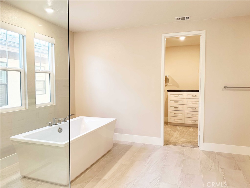 58 Ray Irvine, CA 92618 - Photo 24 of 35 a bathroom with a bathtub and a shower