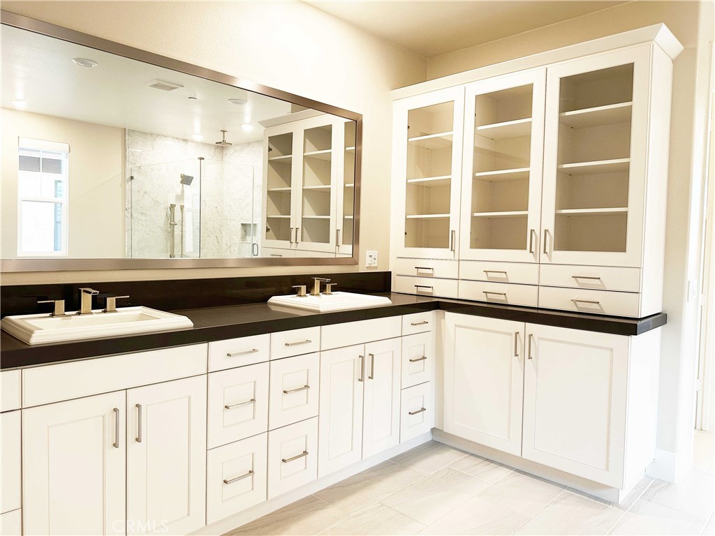 58 Ray Irvine, CA 92618 - Photo 25 of 35 a kitchen with granite countertop a sink and a white cabinets