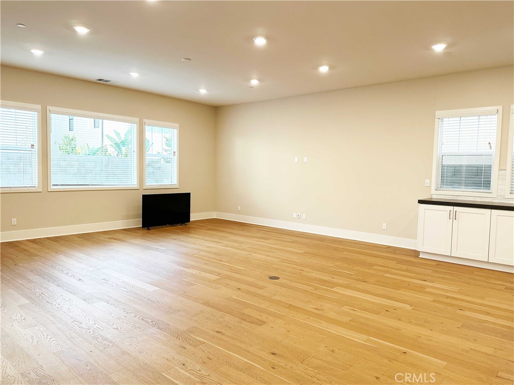58 Ray Irvine, CA 92618 - Photo 5 of 35 an empty room with wooden floor and windows