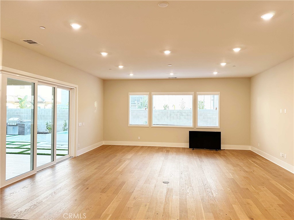 58 Ray Irvine, CA 92618 - Photo 6 of 35 a view of an empty room with wooden floor and a window