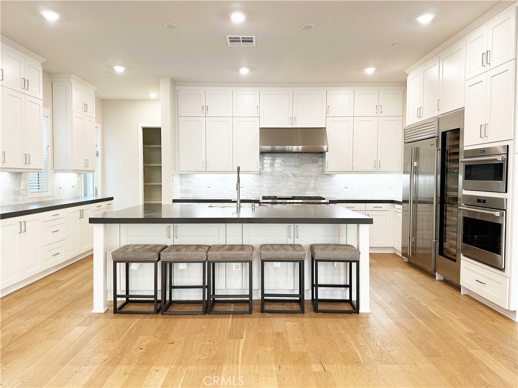58 Ray Irvine, CA 92618 - Photo 7 of 35 a kitchen with stainless steel appliances granite countertop a stove top oven a sink refrigerator and cabinets
