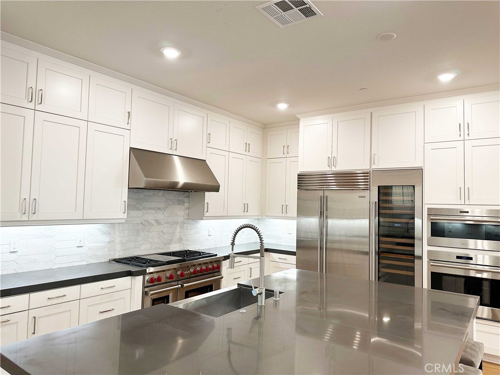 58 Ray Irvine, CA 92618 - Photo 10 of 35 a kitchen with stainless steel appliances granite countertop a stove a sink and a refrigerator