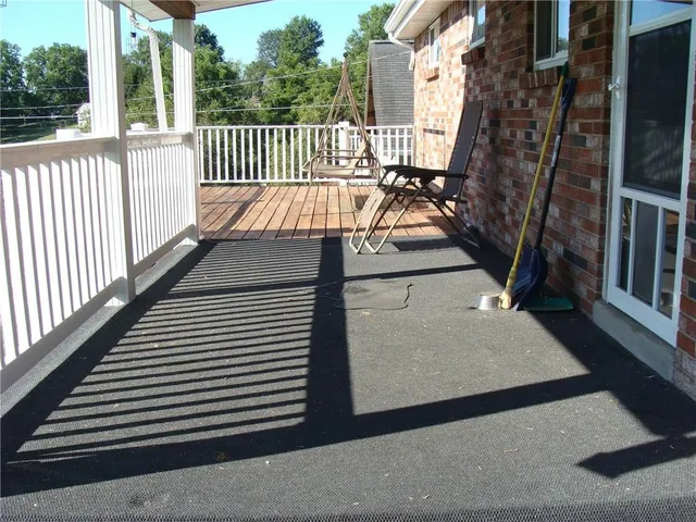 a view of a balcony with wooden floor