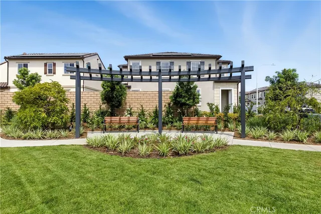 a front view of a house with a yard and lake view