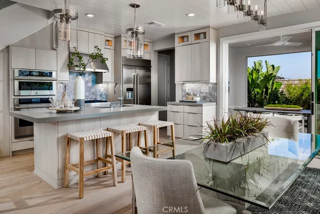a living room with stainless steel appliances kitchen island granite countertop furniture and a dining table