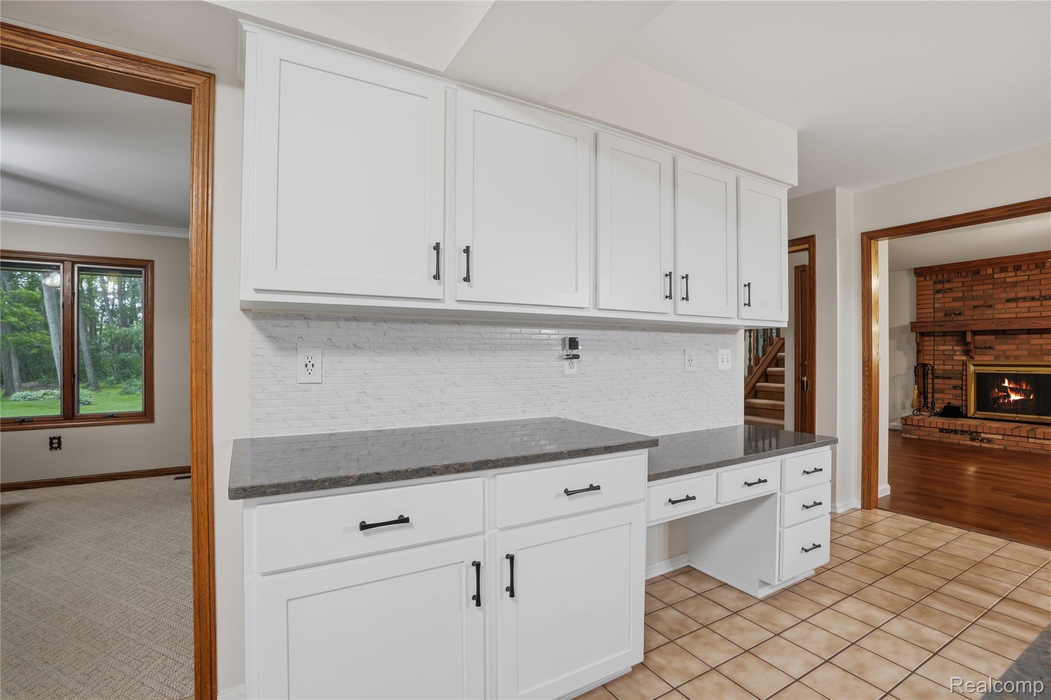68345 Romeo Plank Road Ray, MI 48096 - Photo 22 of 52 White cabinetry with dark hardware, stone countertops, and a white tile backsplash