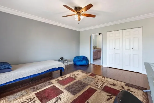 a bedroom with furniture and a rug