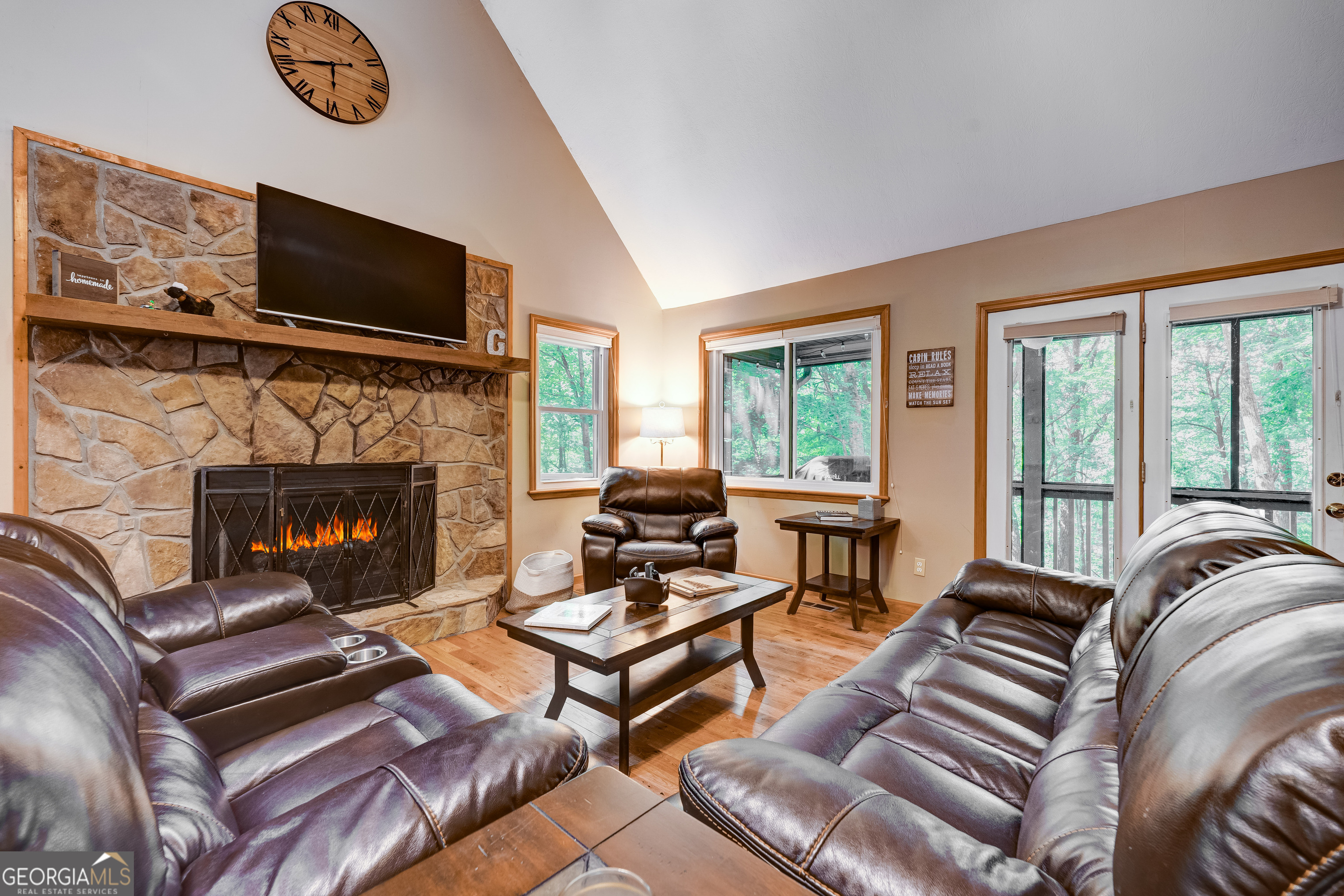 708 Wilson Mountain Road Blairsville, GA 30512 - Photo 11 of 48 a living room with furniture a flat screen tv and a fireplace