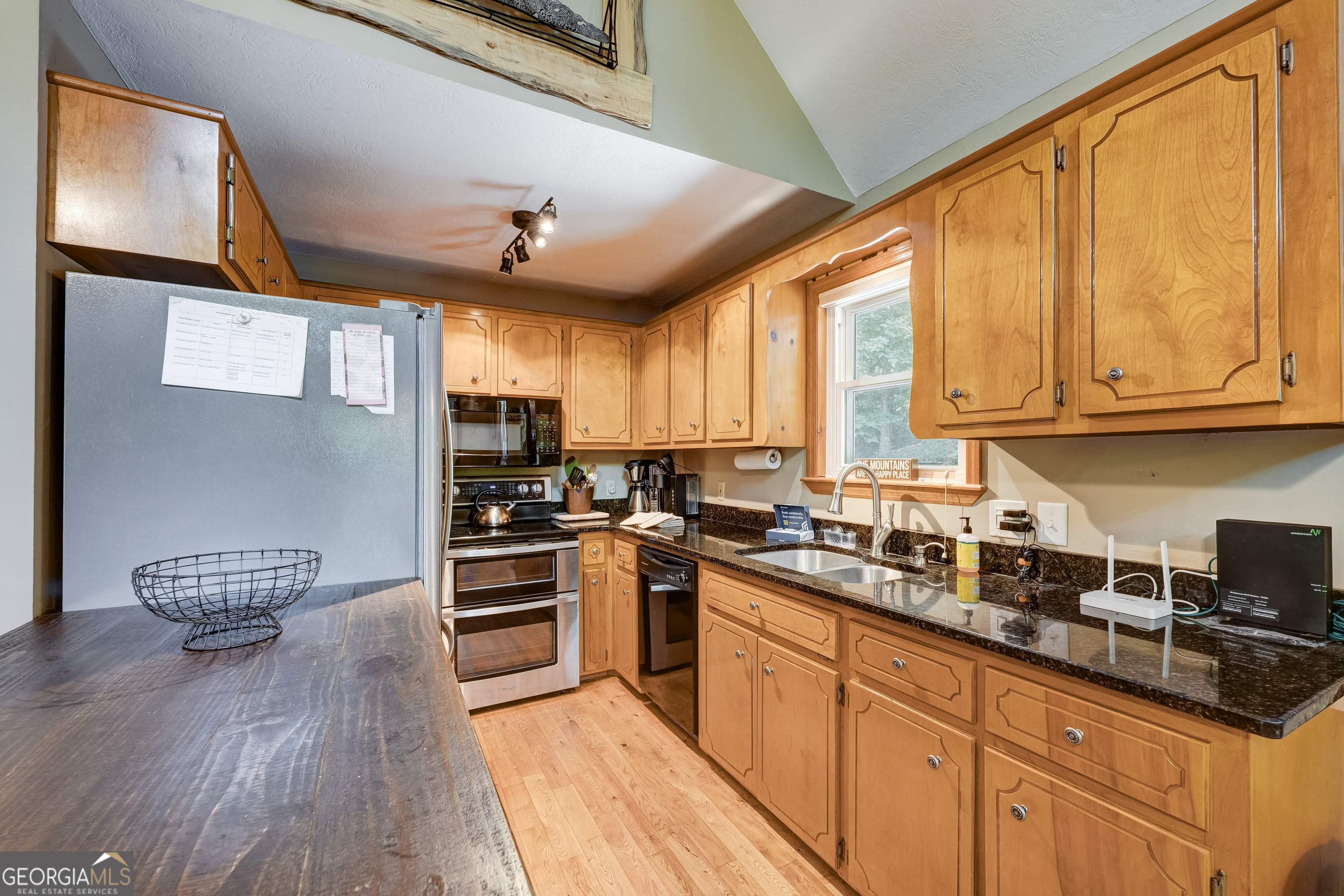 708 Wilson Mountain Road Blairsville, GA 30512 - Photo 13 of 48 a kitchen with stainless steel appliances granite countertop a stove and cabinets