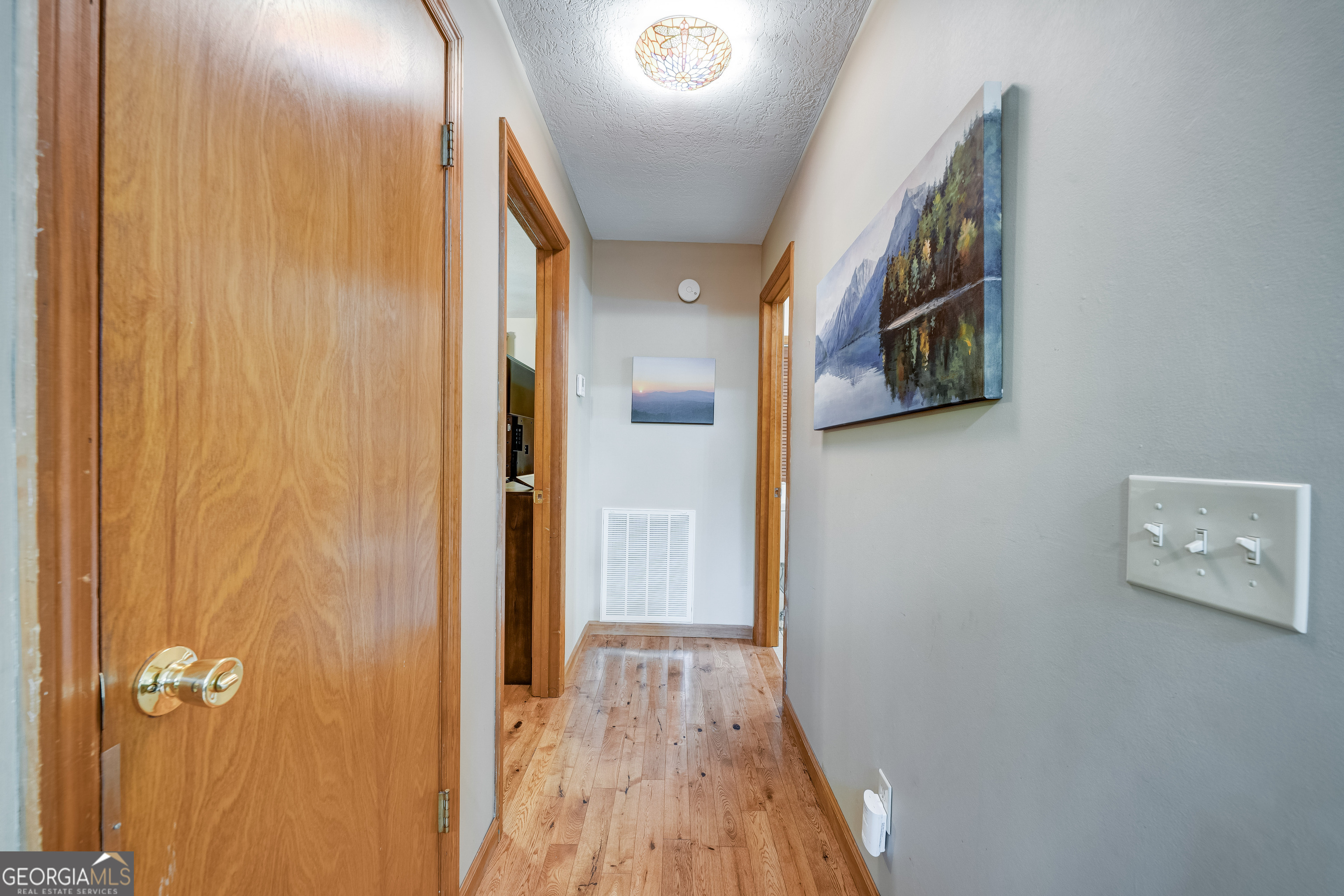 708 Wilson Mountain Road Blairsville, GA 30512 - Photo 16 of 48 a view of a hallway with wooden floor and a bathroom