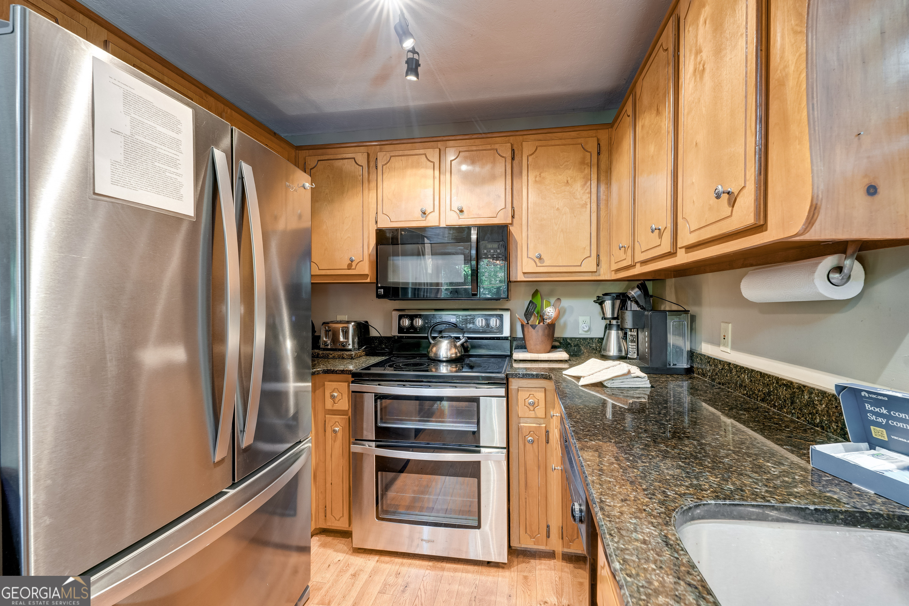 708 Wilson Mountain Road Blairsville, GA 30512 - Photo 17 of 48 a kitchen with stainless steel appliances granite countertop a refrigerator stove and sink