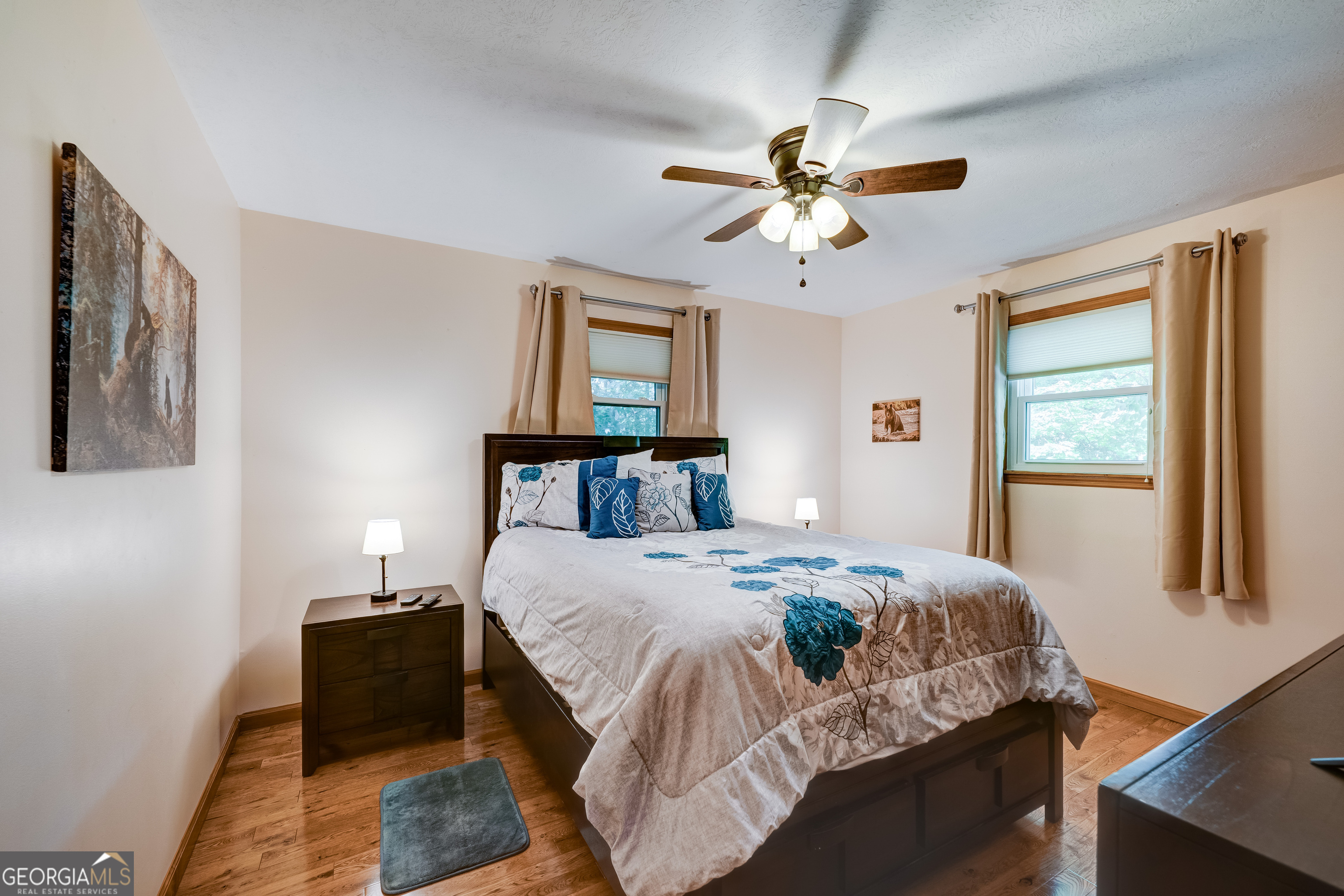 708 Wilson Mountain Road Blairsville, GA 30512 - Photo 18 of 48 a bedroom with a bed and a chandelier