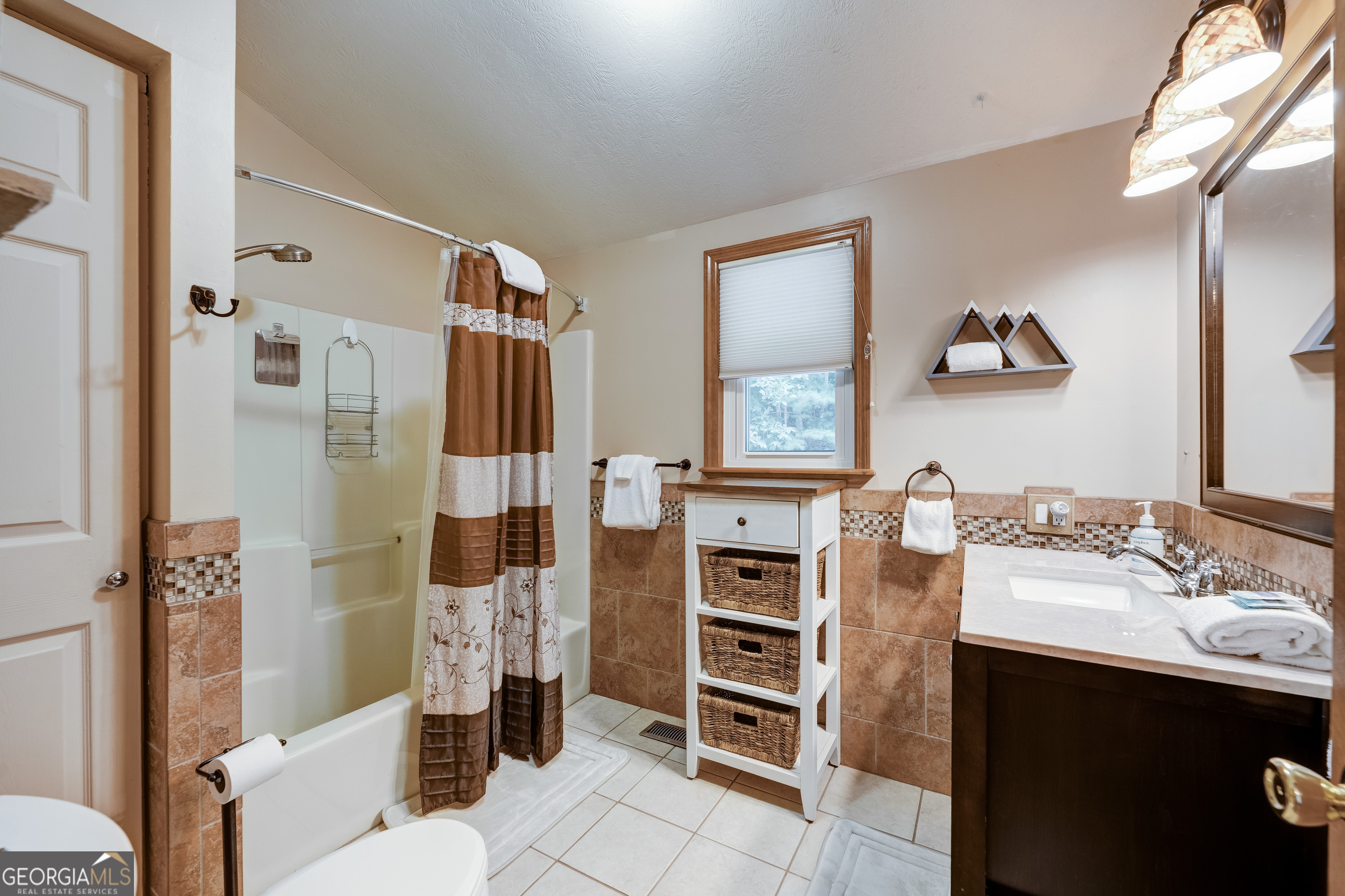 708 Wilson Mountain Road Blairsville, GA 30512 - Photo 27 of 48 a bathroom with a sink toilet and shower