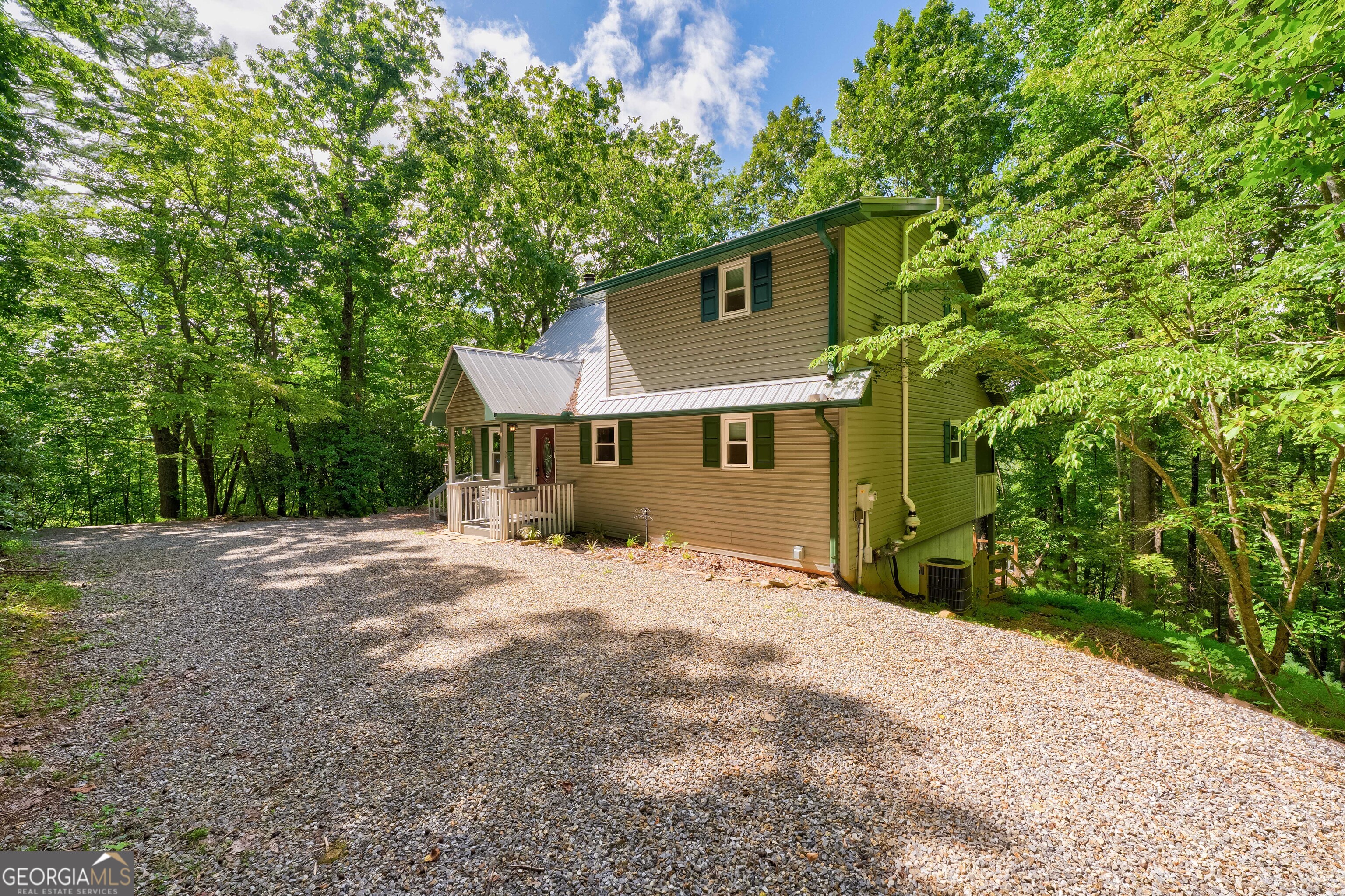 708 Wilson Mountain Road Blairsville, GA 30512 - Photo 7 of 48 a front view of a house with a garden