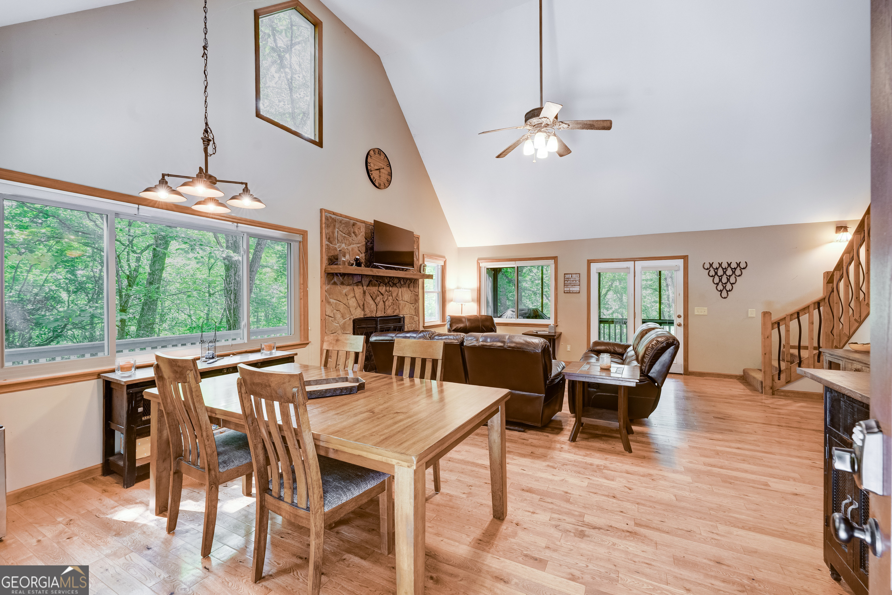708 Wilson Mountain Road Blairsville, GA 30512 - Photo 9 of 48 a dining room with wooden floor a chandelier a glass table and chairs
