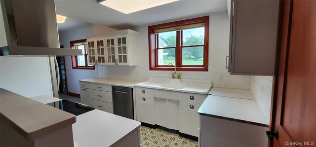 a kitchen with a refrigerator and a sink