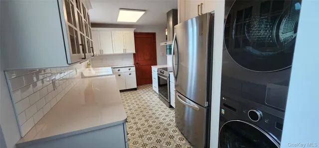 a view of a livingroom with wooden floor and a fireplace