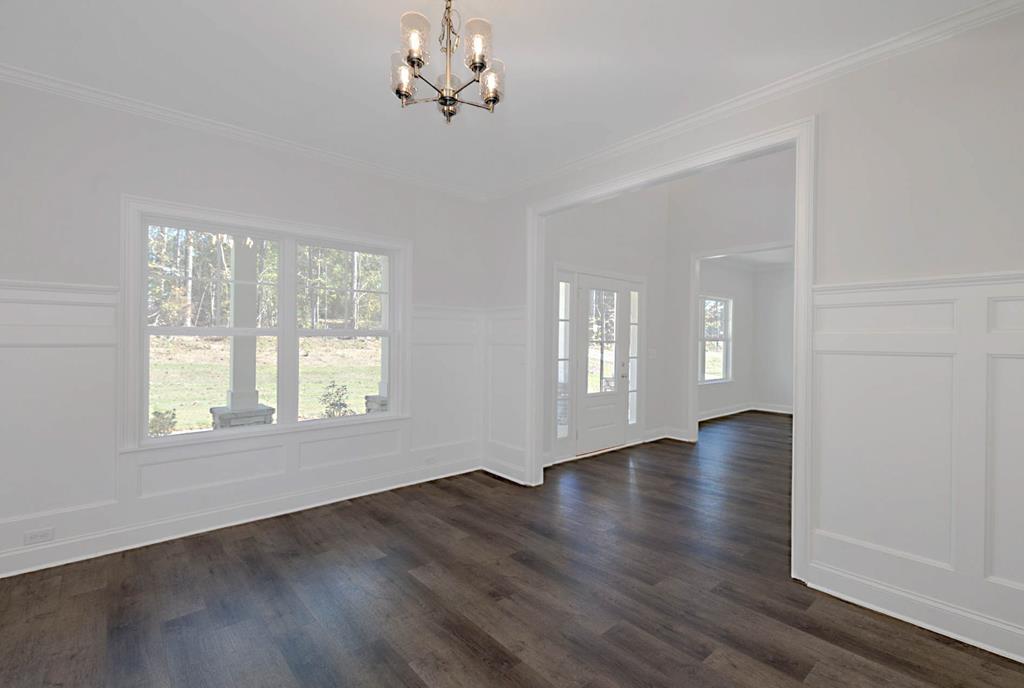 8705 McKee Road Upatoi, GA 31829 - Photo 15 of 42 a view of an empty room with wooden floor and a window