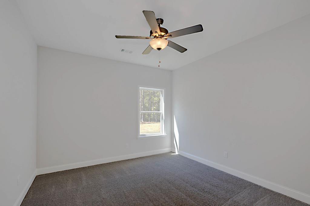 8705 McKee Road Upatoi, GA 31829 - Photo 20 of 42 an empty room with a window and a fan
