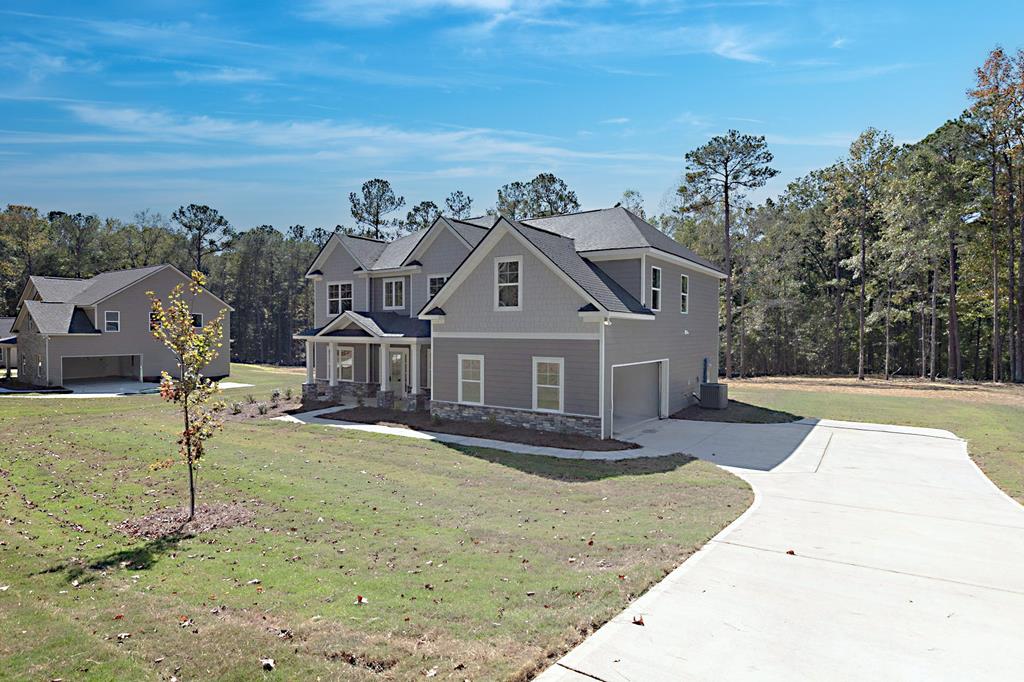 8705 McKee Road Upatoi, GA 31829 - Photo 3 of 42 a front view of a house with a yard
