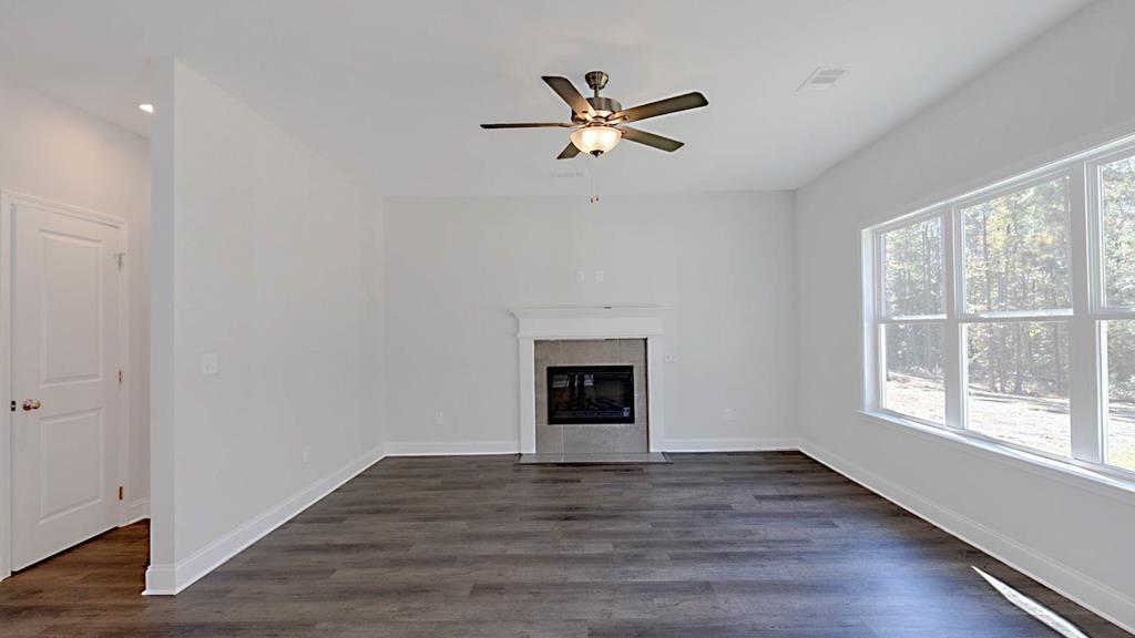 8705 McKee Road Upatoi, GA 31829 - Photo 4 of 42 a view of empty room with wooden floor and fan