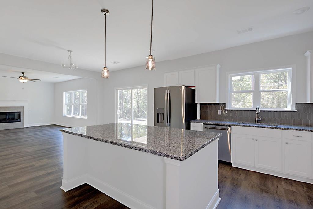 8705 McKee Road Upatoi, GA 31829 - Photo 8 of 42 a kitchen with stainless steel appliances granite countertop a sink a stove and refrigerator