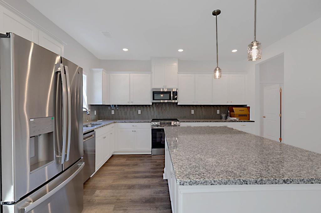 8705 McKee Road Upatoi, GA 31829 - Photo 10 of 42 a kitchen with stainless steel appliances granite countertop a refrigerator a oven and a sink with granite countertops