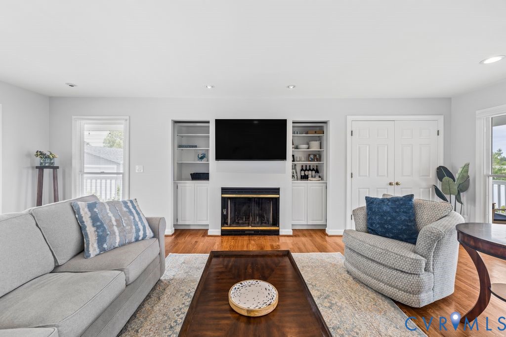2082 Ocran Road White Stone, VA 22578 - Photo 11 of 50 a living room with furniture a fireplace and a flat screen tv