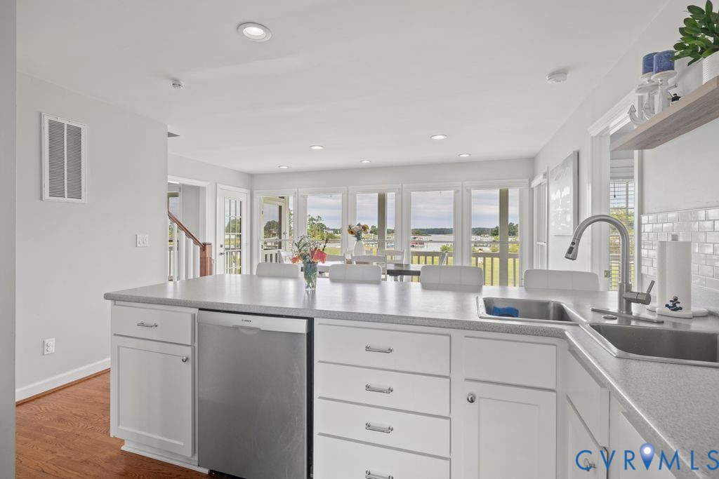 2082 Ocran Road White Stone, VA 22578 - Photo 16 of 50 a kitchen with white cabinets and sink