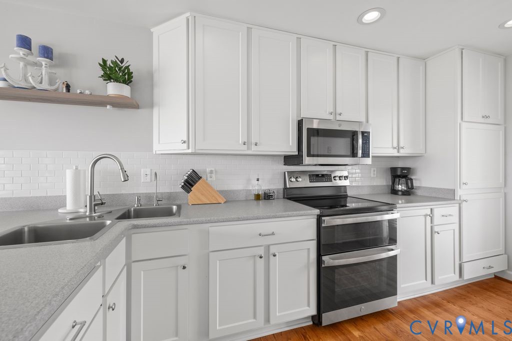 2082 Ocran Road White Stone, VA 22578 - Photo 17 of 50 a kitchen with white cabinets and stainless steel appliances