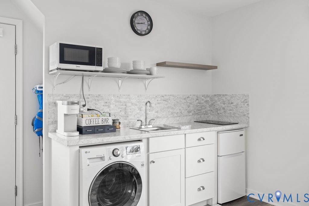 2082 Ocran Road White Stone, VA 22578 - Photo 32 of 50 a view of a kitchen with stainless steel appliances granite countertop a sink and a microwave
