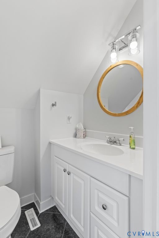 2082 Ocran Road White Stone, VA 22578 - Photo 33 of 50 a bathroom with a toilet a sink and mirror
