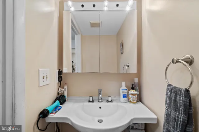 a bathroom with a sink a toilet and a mirror