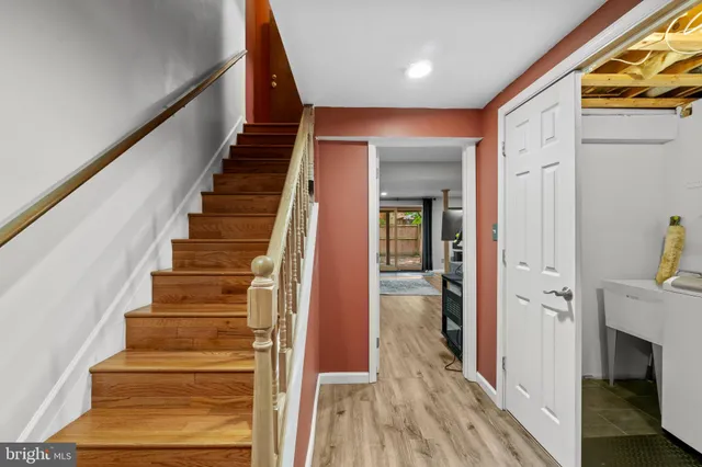 a view of entryway and gallery with wooden floor