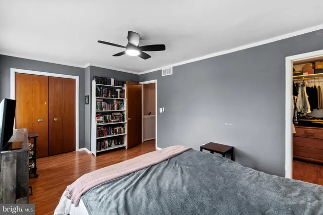 a bedroom with a large bed and a television